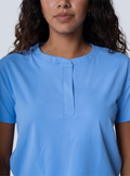 ALTA Kenzie Two-Pocket Scrub Top in Ceil Blue - fabric and pocket detail