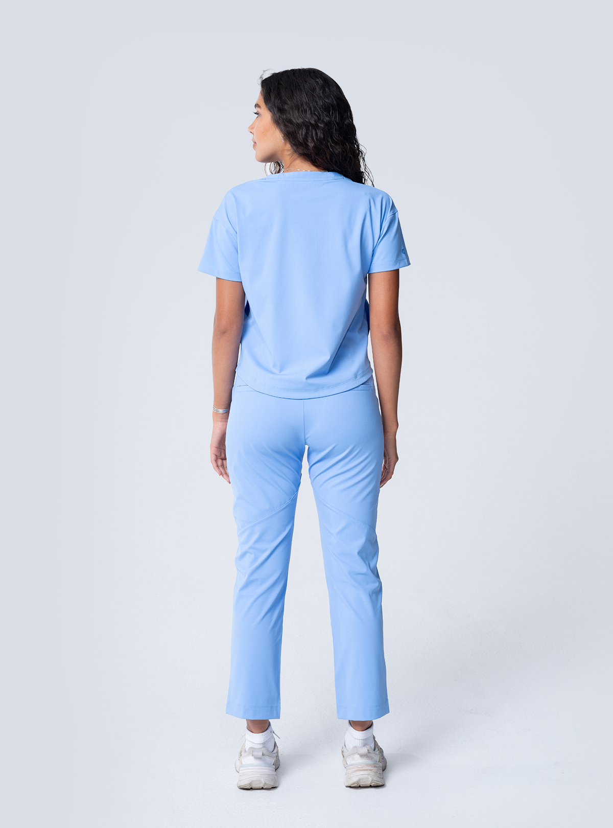 ALTA Kenzie Two-Pocket Scrub Top in Ceil Blue - full back view