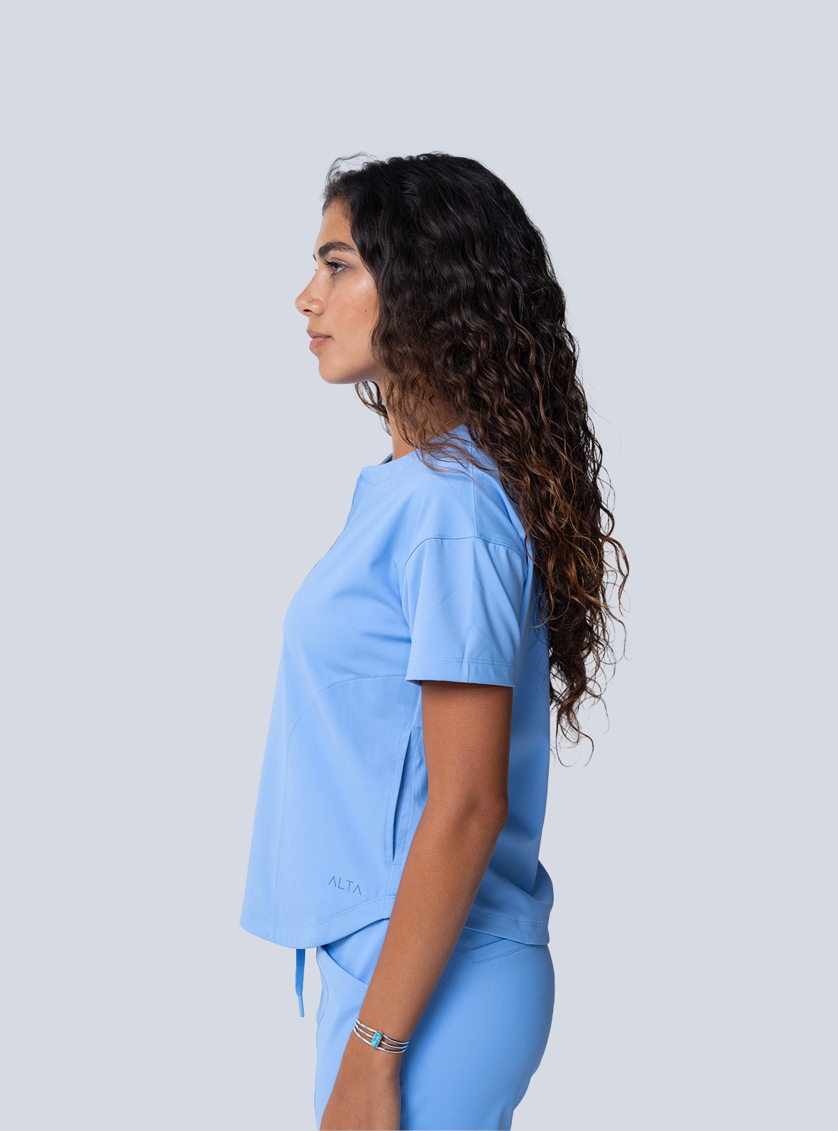 ALTA Kenzie Two-Pocket Scrub Top in Ceil Blue - side view